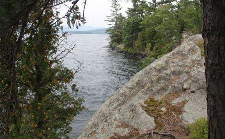 a rocky cliff overlooking a lake