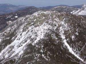 aerial view of several snow-covered mountain summits