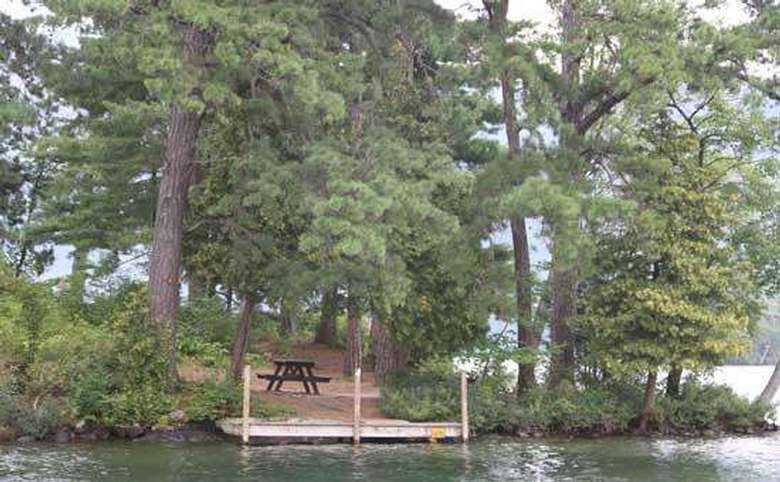 a wide wooden dock on the shoreline of an island