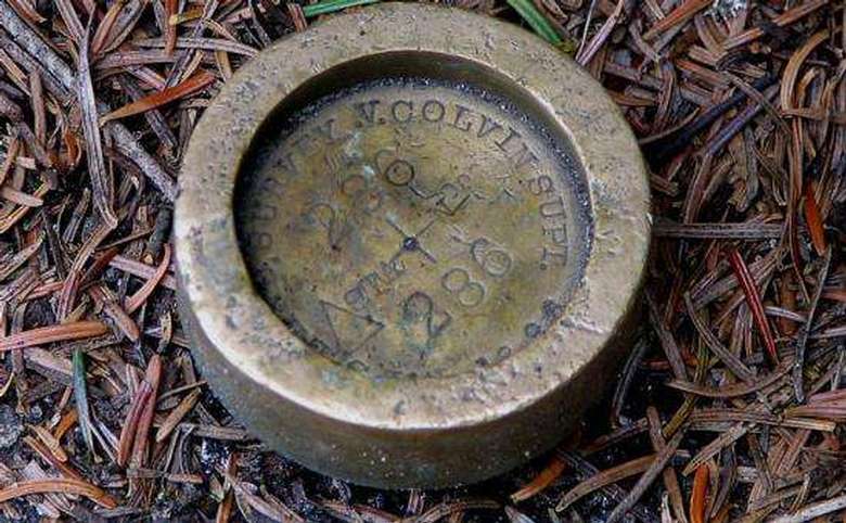 bronze survey marker in the ground