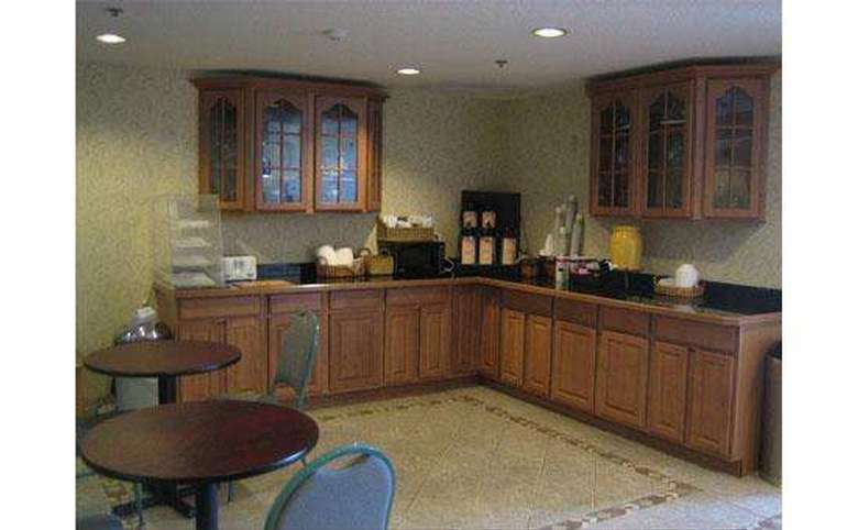 Kitchenette in room with two tables and coffee