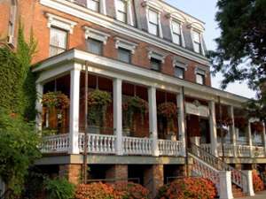 the exterior of a brick and white hotel