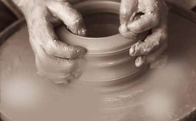 artist working with clay on a wheel