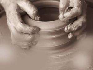 artist working with clay on a wheel