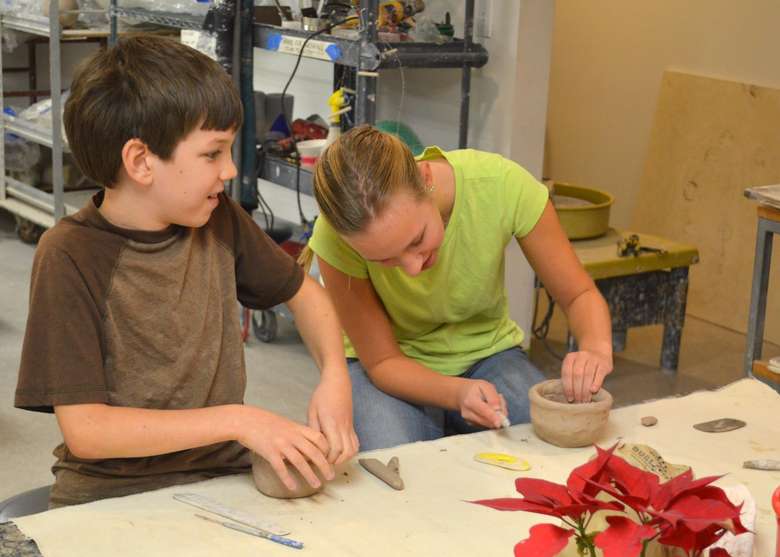 two kids working with clay