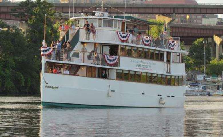 cruise boat decorated with american flags on the hudson river