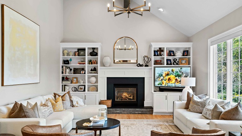 a large living room with a fireplace and nearby shelves