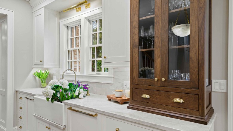 dark brown cabinet with drink glasses on a countertop