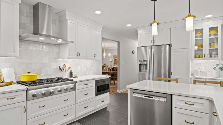 a modern kitchen with white and chrome theme