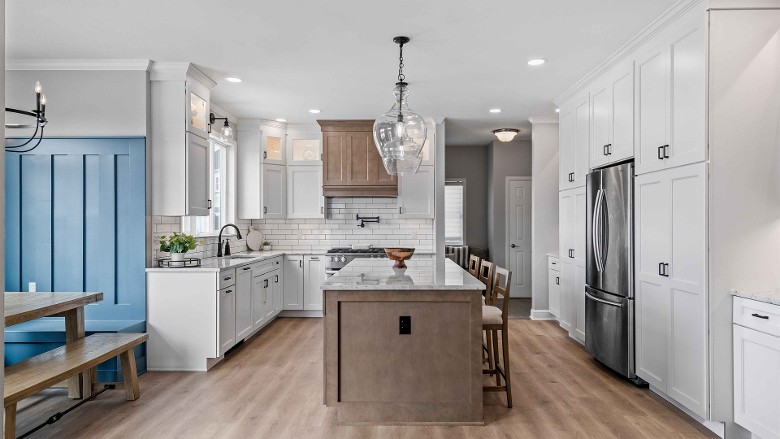 a large modern kitchen with wooden flooring and an island