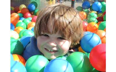 boy in colorful ball pit