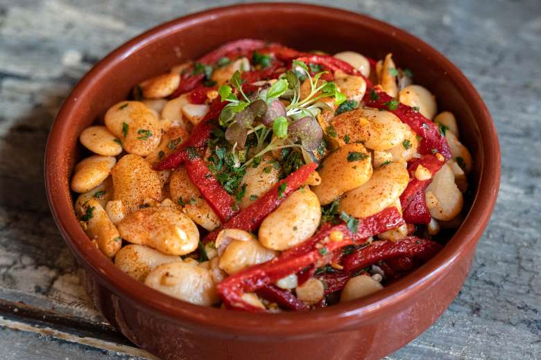 butterbeans and piquillo peppers tapa in a red bowl