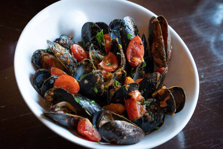 sauteed mussels in a white bowl