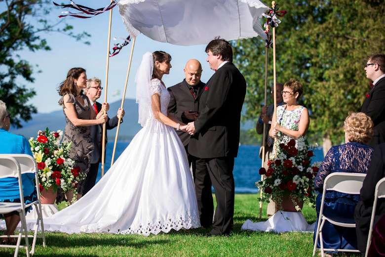 Couple being married by the lake