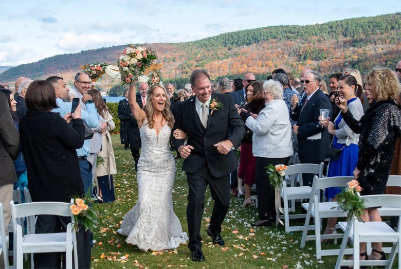 married couple walking up aisle