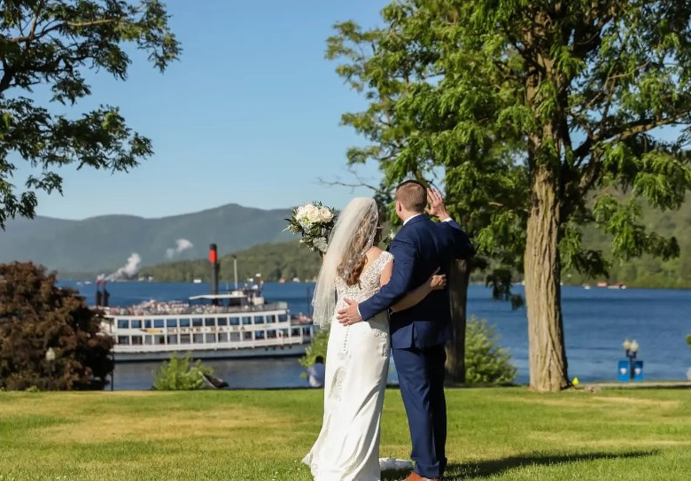 bride and groom waving at steamboat
