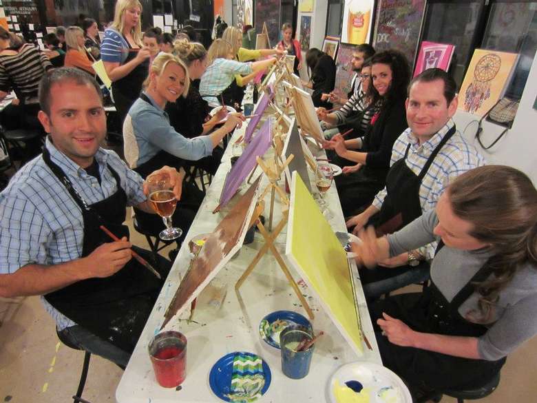group of people painting during a paint and sip