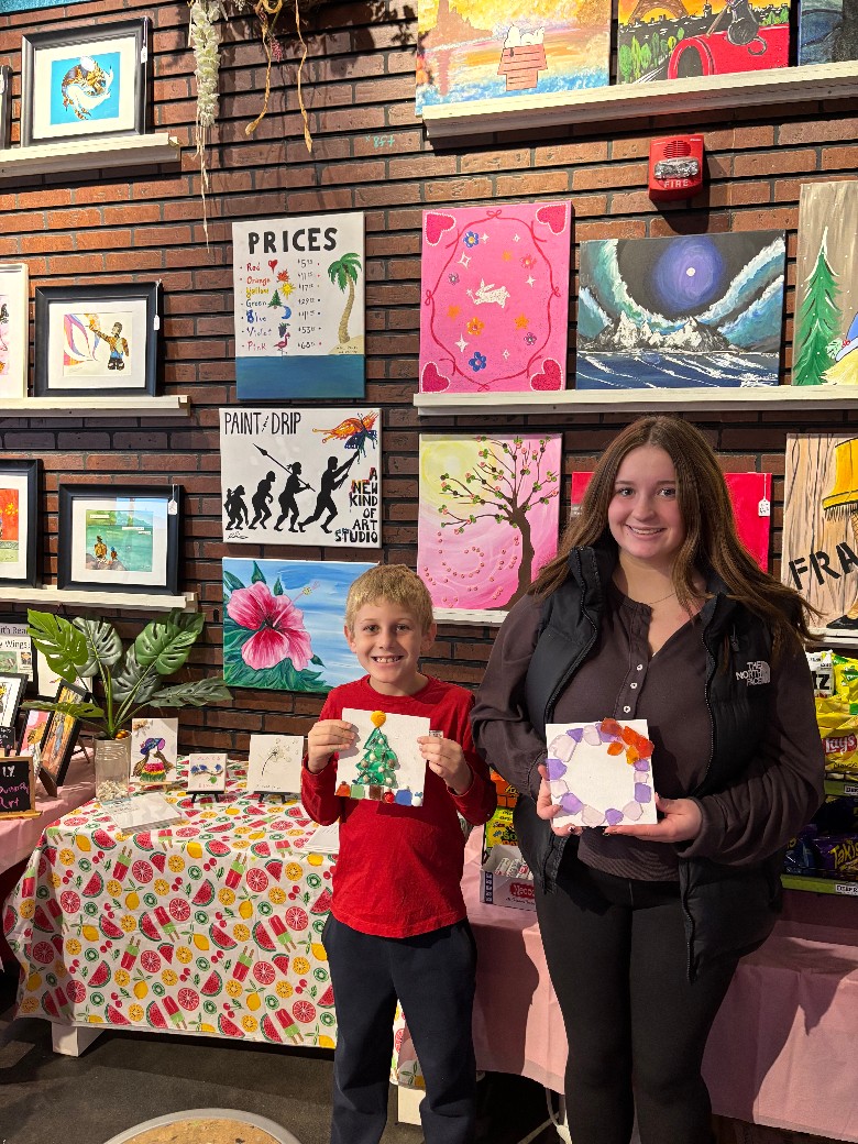 woman and boy with artworks