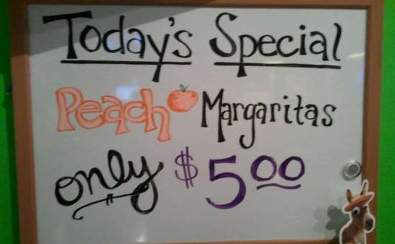 A sign that states Today's Special, Peach Margaritas, only five dollars.