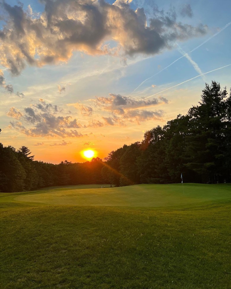 a sunset on a golf course