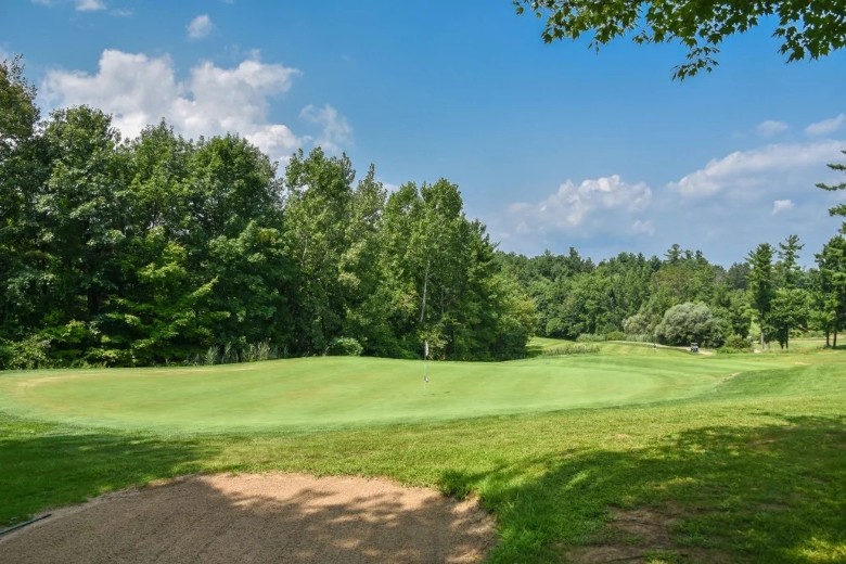 a scenic golf course on a sunny day with blue sky