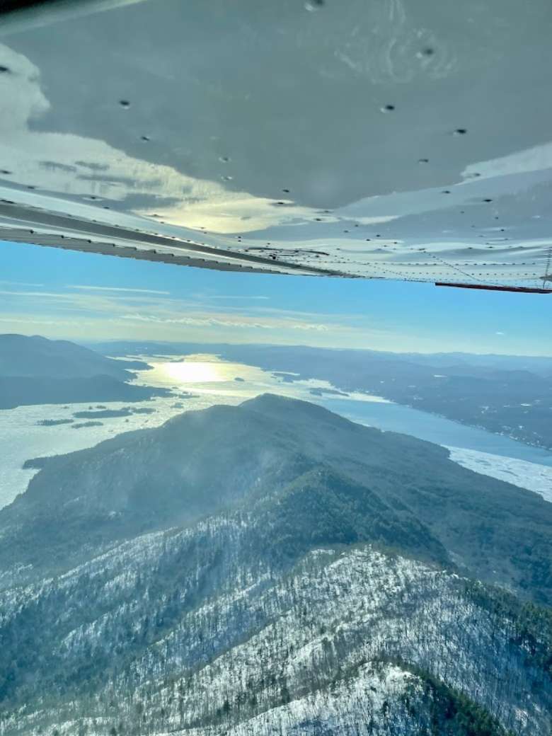view from aircraft over mountain and lake