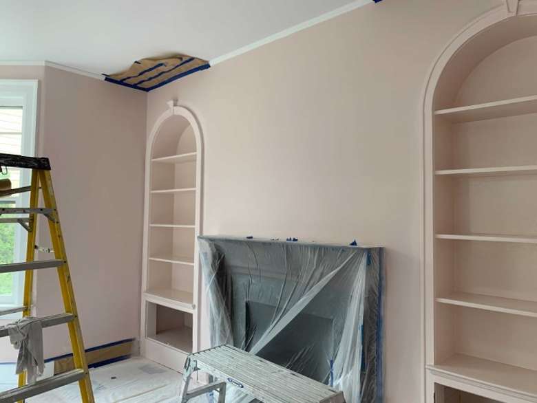 salmon colored walls around a fireplace during construction project