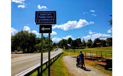 Feeder Canal trail sign, person walking with stroller