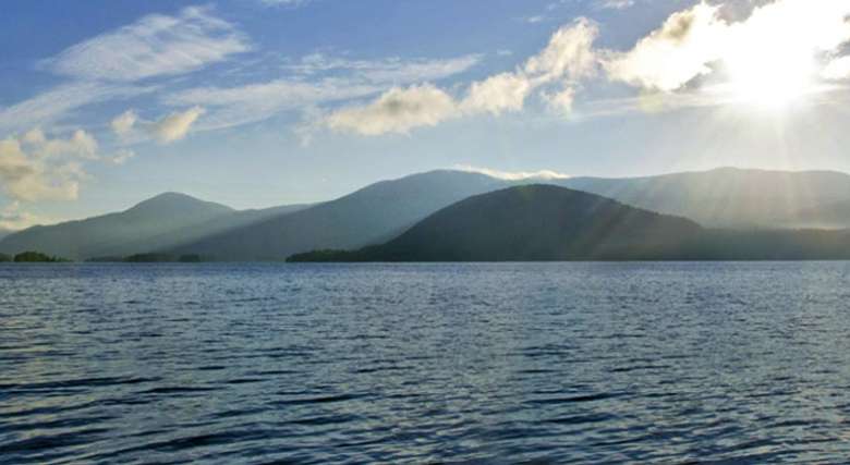 view of lake george with mountains in the background