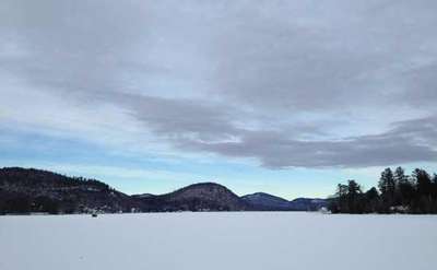 brant lake in winter covered in snow