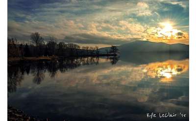 photography by kyle leclair of setting sun reflected off chazy lake