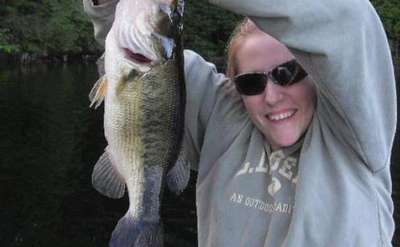 woman holding up fish caught at lincoln pond