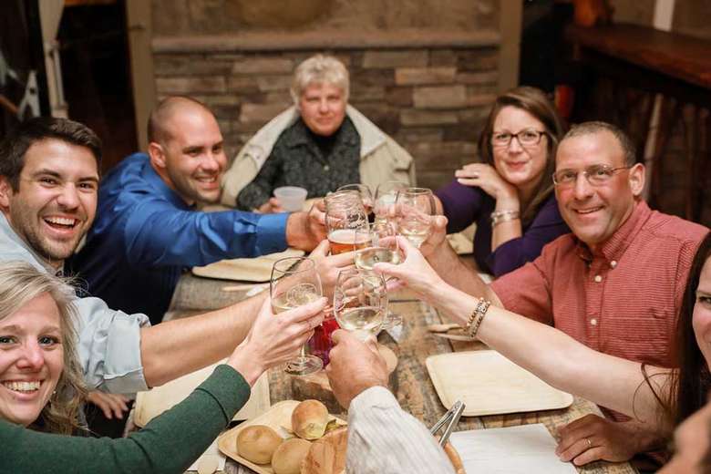 group of people raising glasses at a table