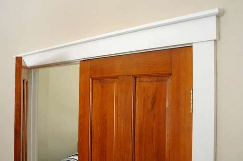 white trim surrounding a pair of wooden doors