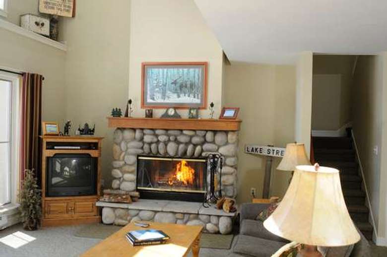stone fireplace with a fire burning