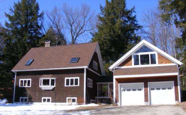 large brown house with a two car garage