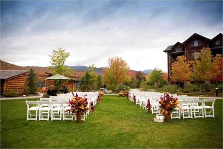 chairs set up for an outdoor wedding ceremony in the fall