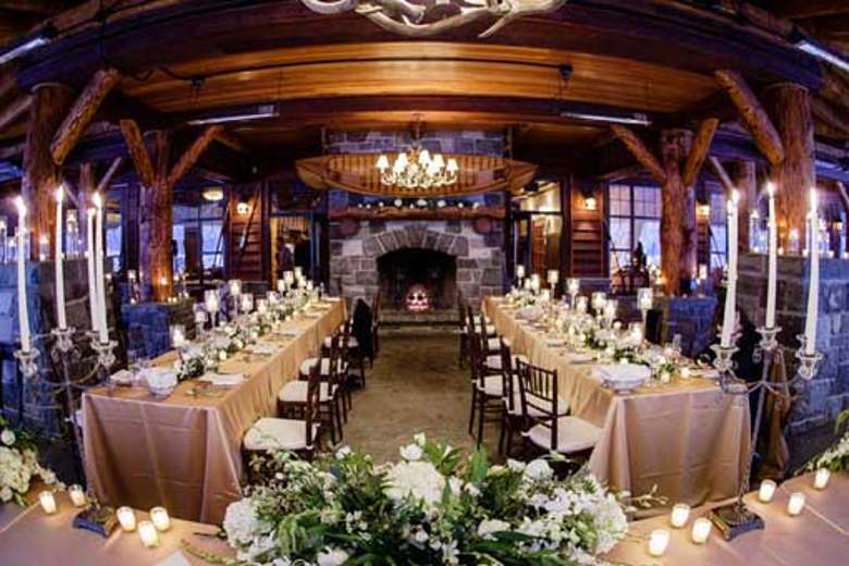 tables set up for a wedding reception in a rustic adirondack-style room