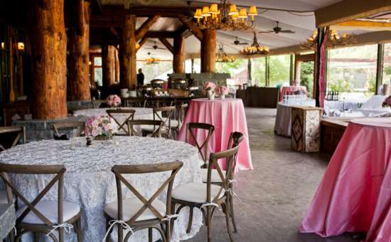 tables set up for a wedding reception in a rustic room