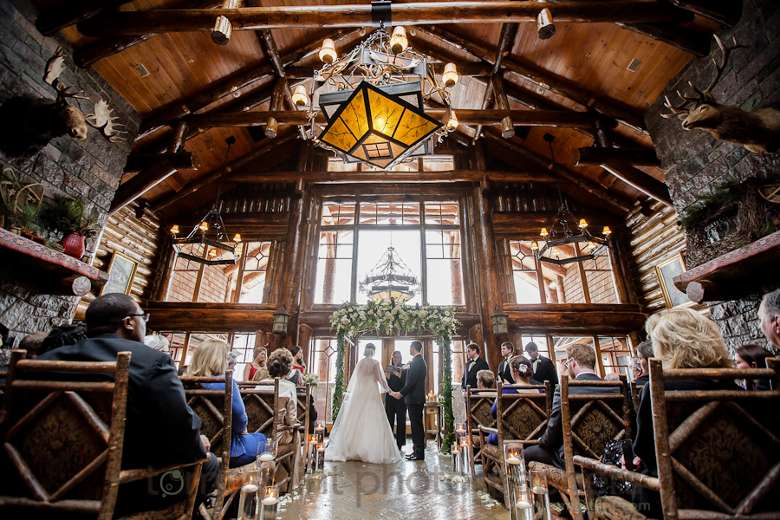 wedding ceremony inside an adirondack lodge-style great room