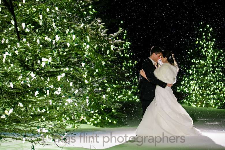 bride and groom posing outside at night