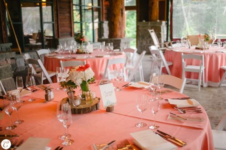 wedding reception tables decorated with peach tablecloths