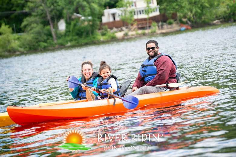 two adults and one girl in kayaks