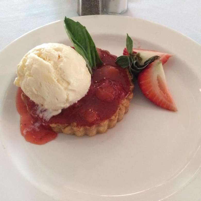 strawberry tart with a scoop of vanilla ice cream