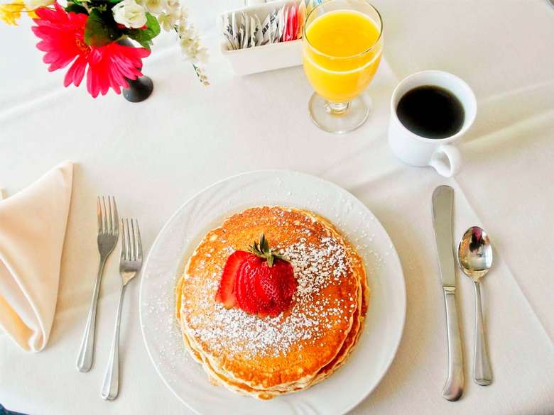 pancakes, coffee, and orange juice on a table