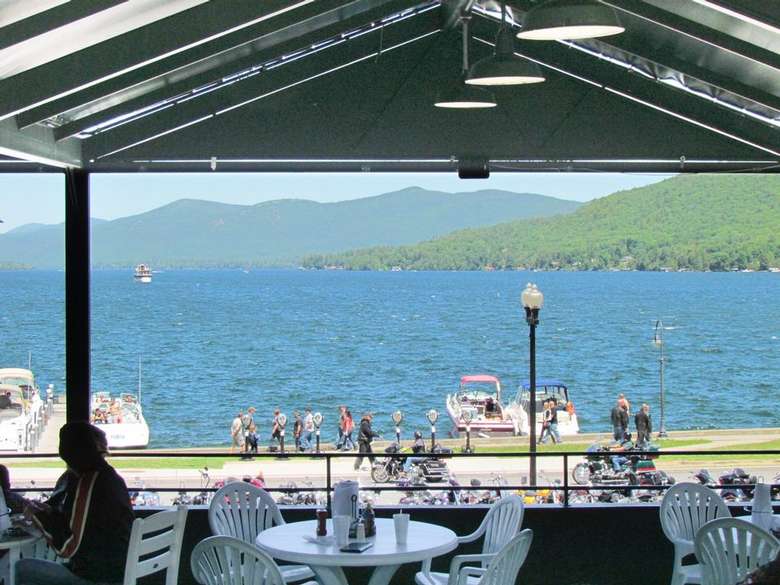 view of a lake from a patio dining area
