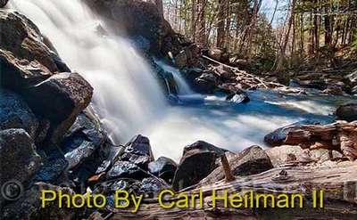 waterfall dropping into a pool with photo credit to carl heilman ii