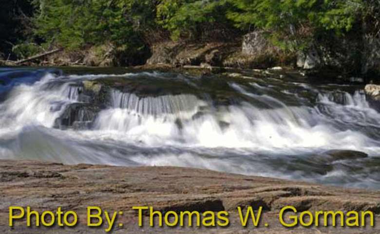 shallow rushing waterfall with photo credit to thomas w. gorman