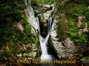 steep waterfall dropping into a pool with photo credit to john haywood