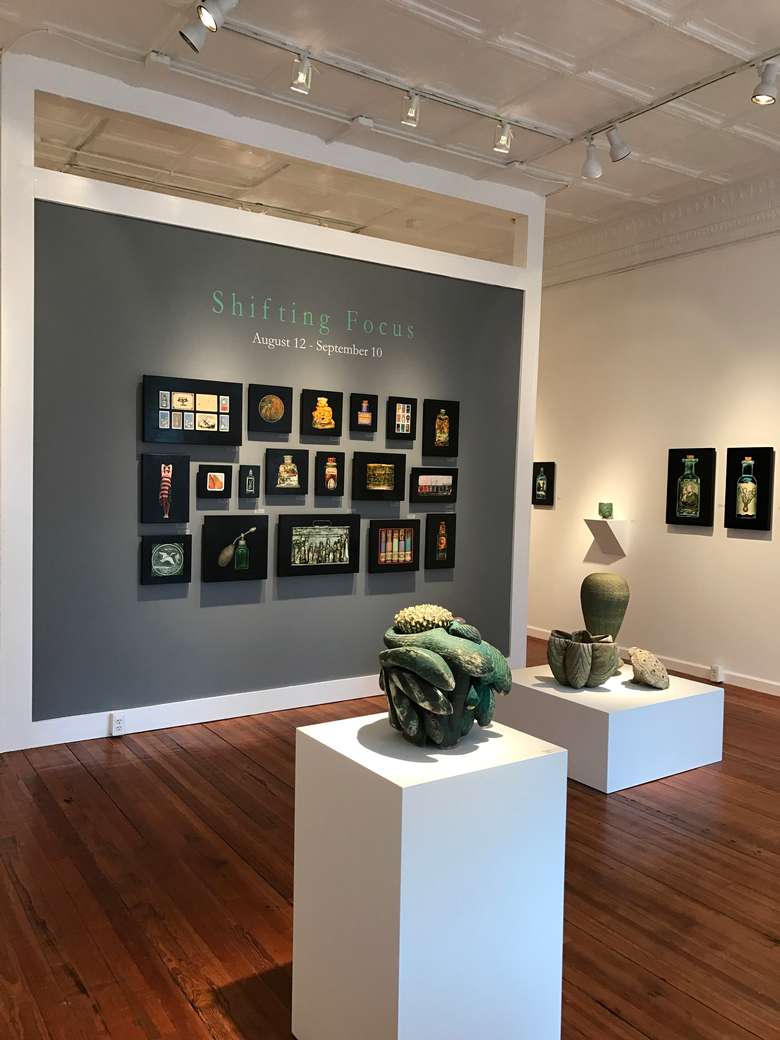 art gallery showing the shifting focus exhibition with sculptures and paintings on the walls